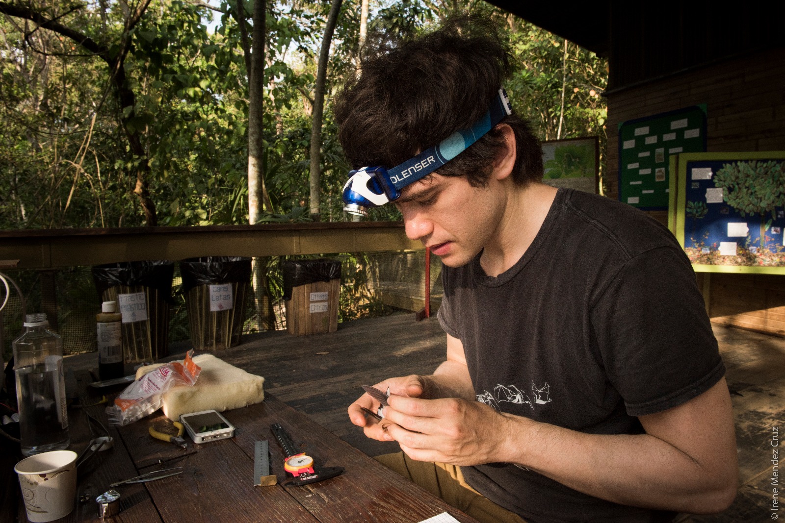 Photo of Jay working at a table in the forest